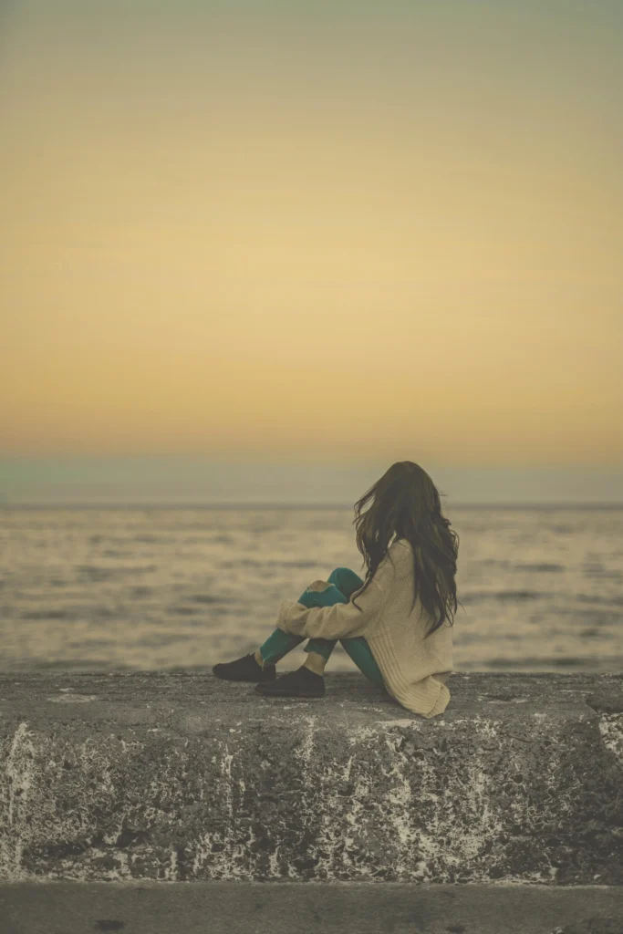 2-Get-There|Lifelong Learning, Global Citizenship, Creative Expression|Woman sitting on a seawall at Sunset